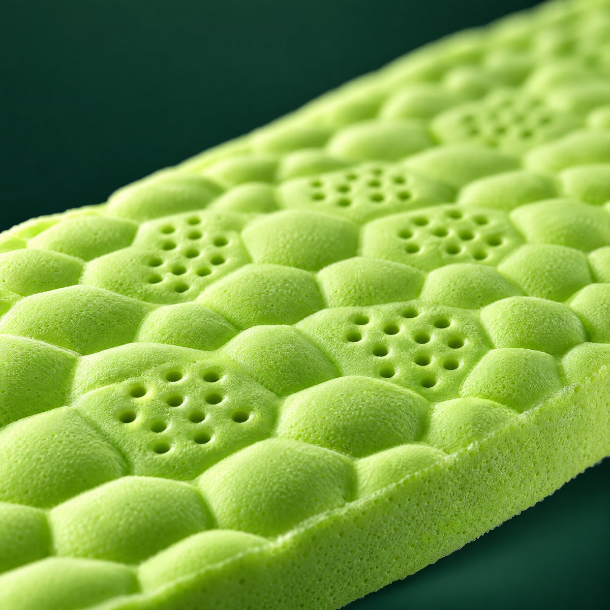 Macro close-up of the EMPOFIT foam: honeycomb cells, ventilation holes and the depth of the cushioning